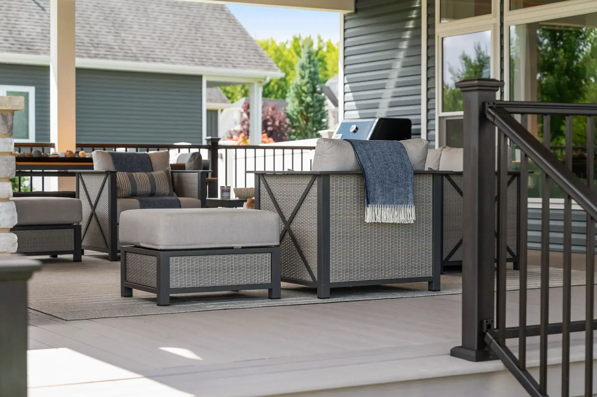 Covered porch seating area on composite decking in Medina, Ohio by TAB Property Enhancement