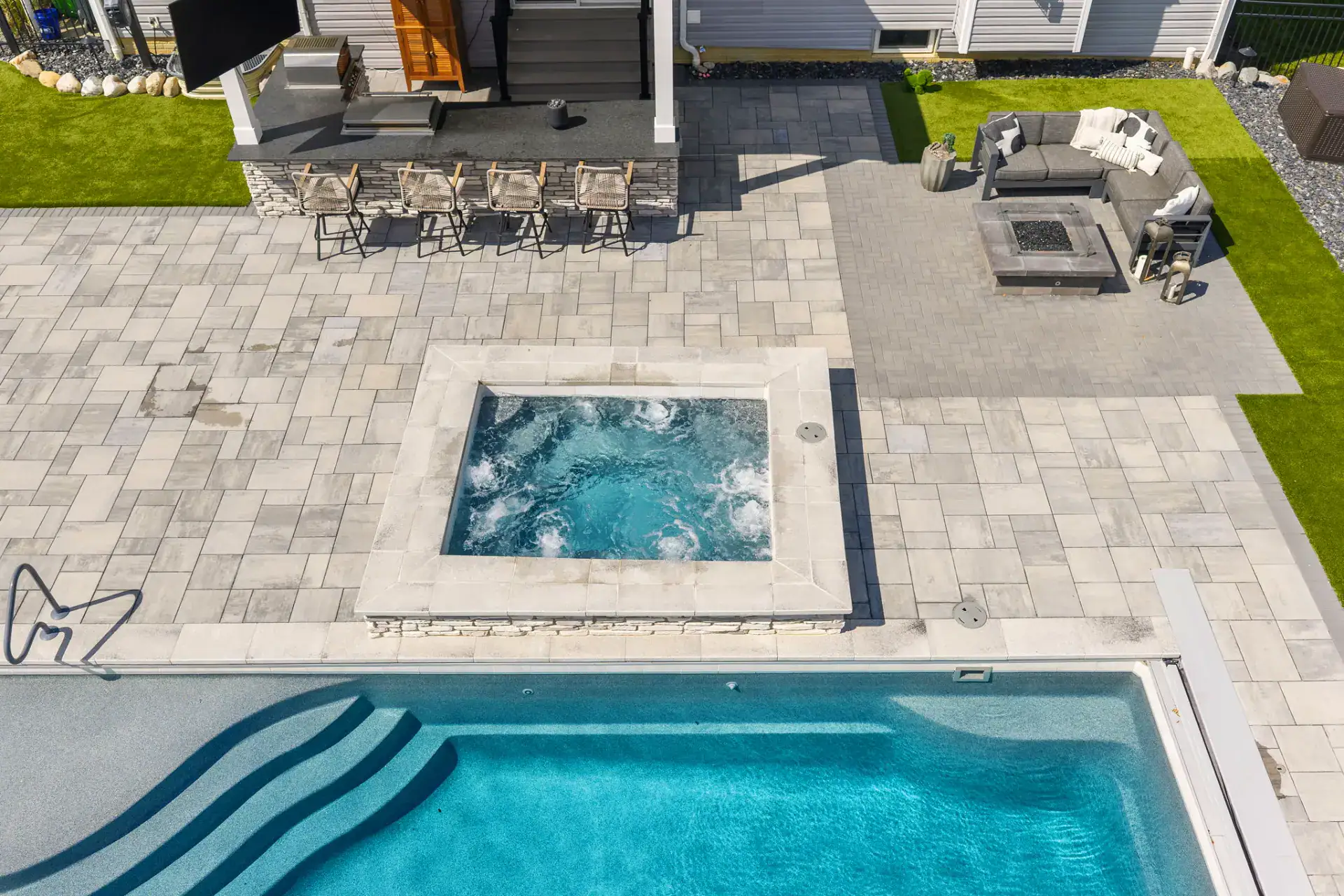Paver Pool Deck with Outdoor Kitchen and Turf in Medina