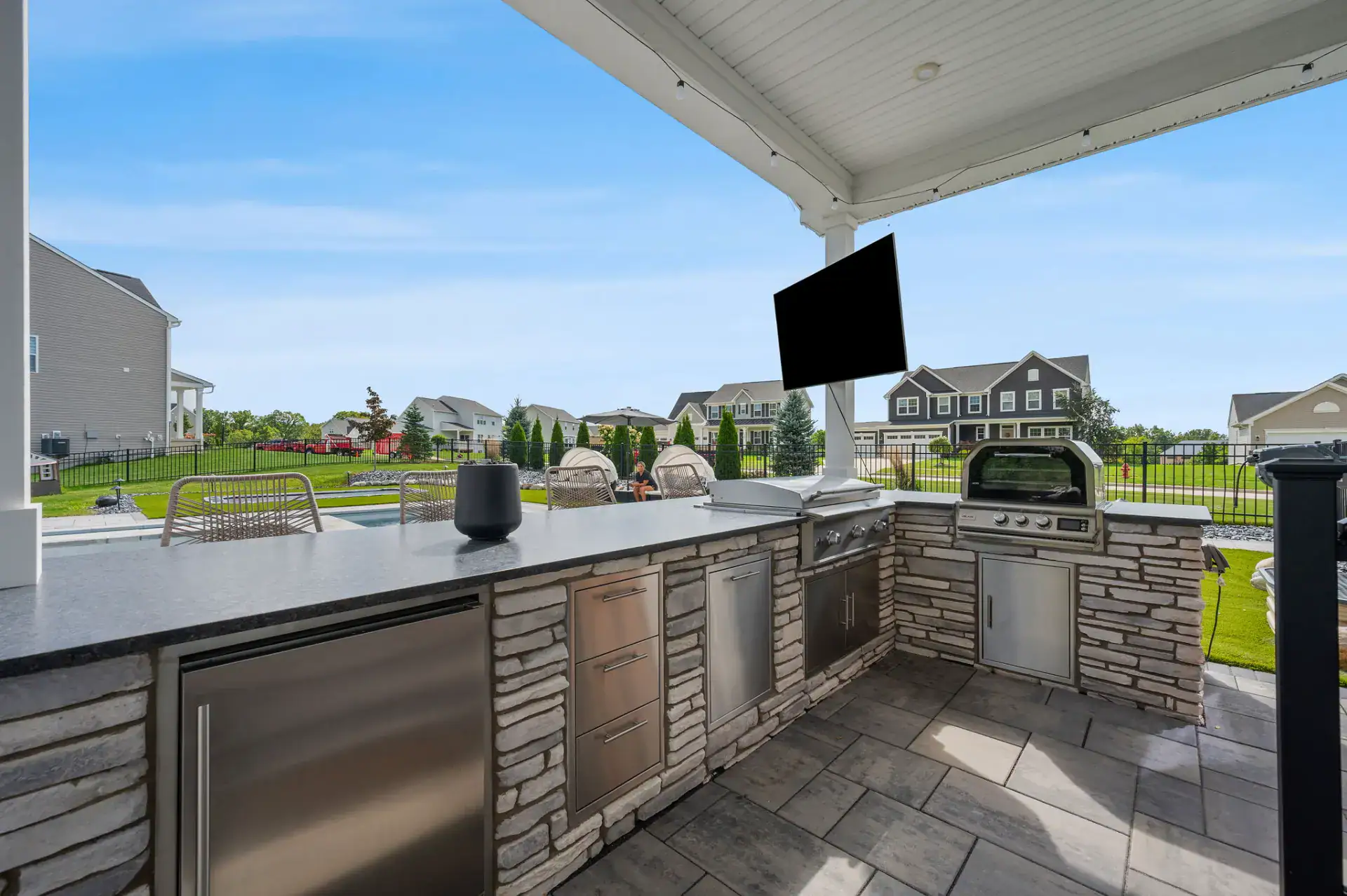 L-shaped outdoor kitchen with built-in grill and pizza oven in Medina, Ohio by TAB Property Enhancement