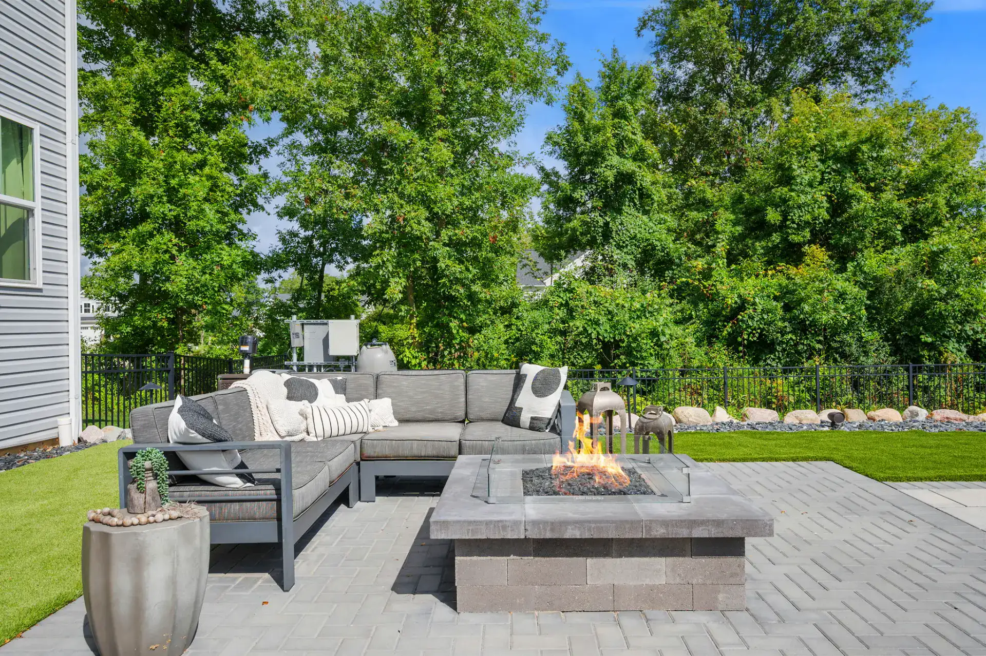 Gas fire pit on a herringbone paver patio in Medina, Ohio by TAB Property Enhancement