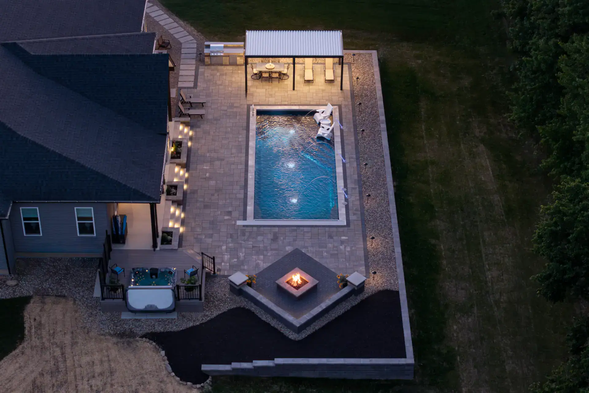 Aerial view of paver pool deck, pergola, and gas fire pit in Hinckley, Ohio by TAB Property Enhancement