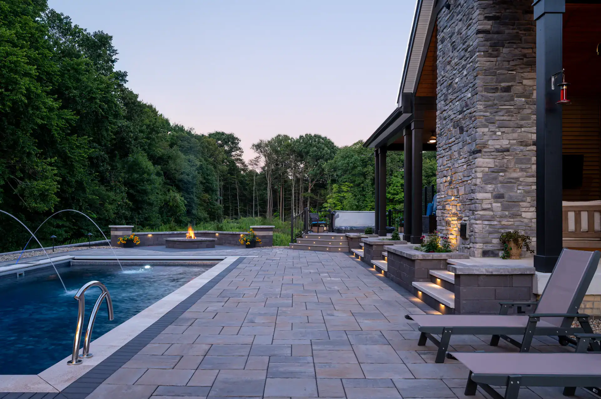 Louvered aluminum pergola with LED lighting over paver dining patio in Hinckley, Ohio by TAB Property Enhancement