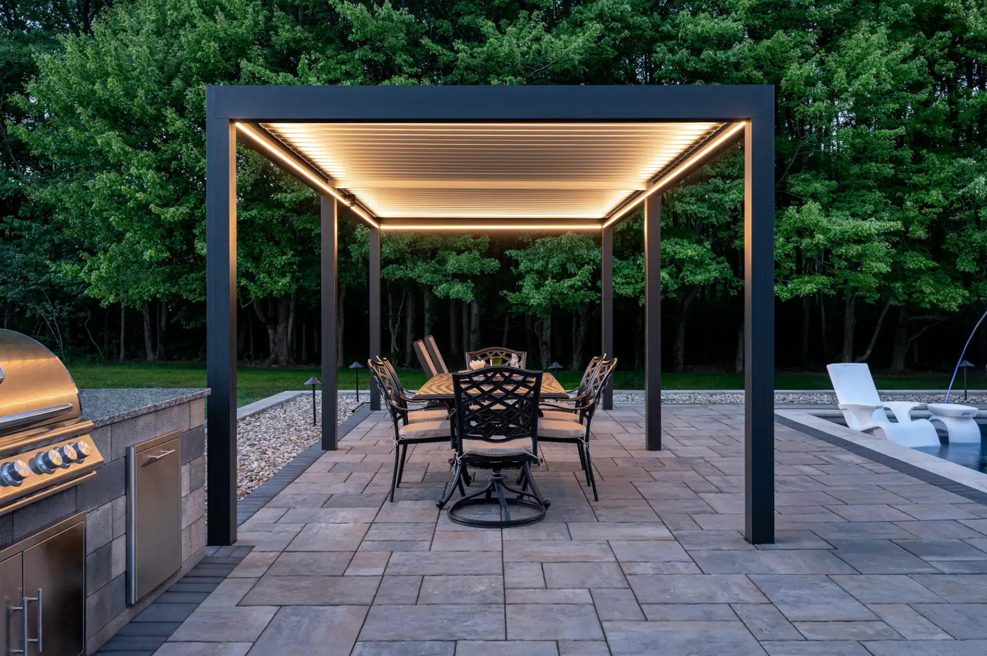 Paver pool deck and gas fire pit with seat wall in Hinckley, Ohio by TAB Property Enhancement