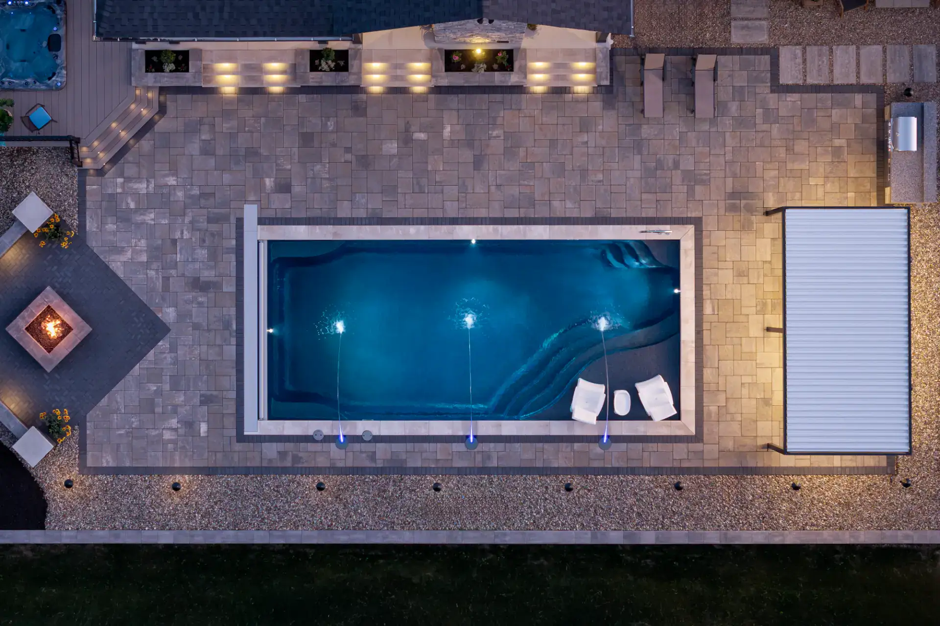 Overhead view of paver patio, pool deck, and fire pit in Hinckley, Ohio by TAB Property Enhancement