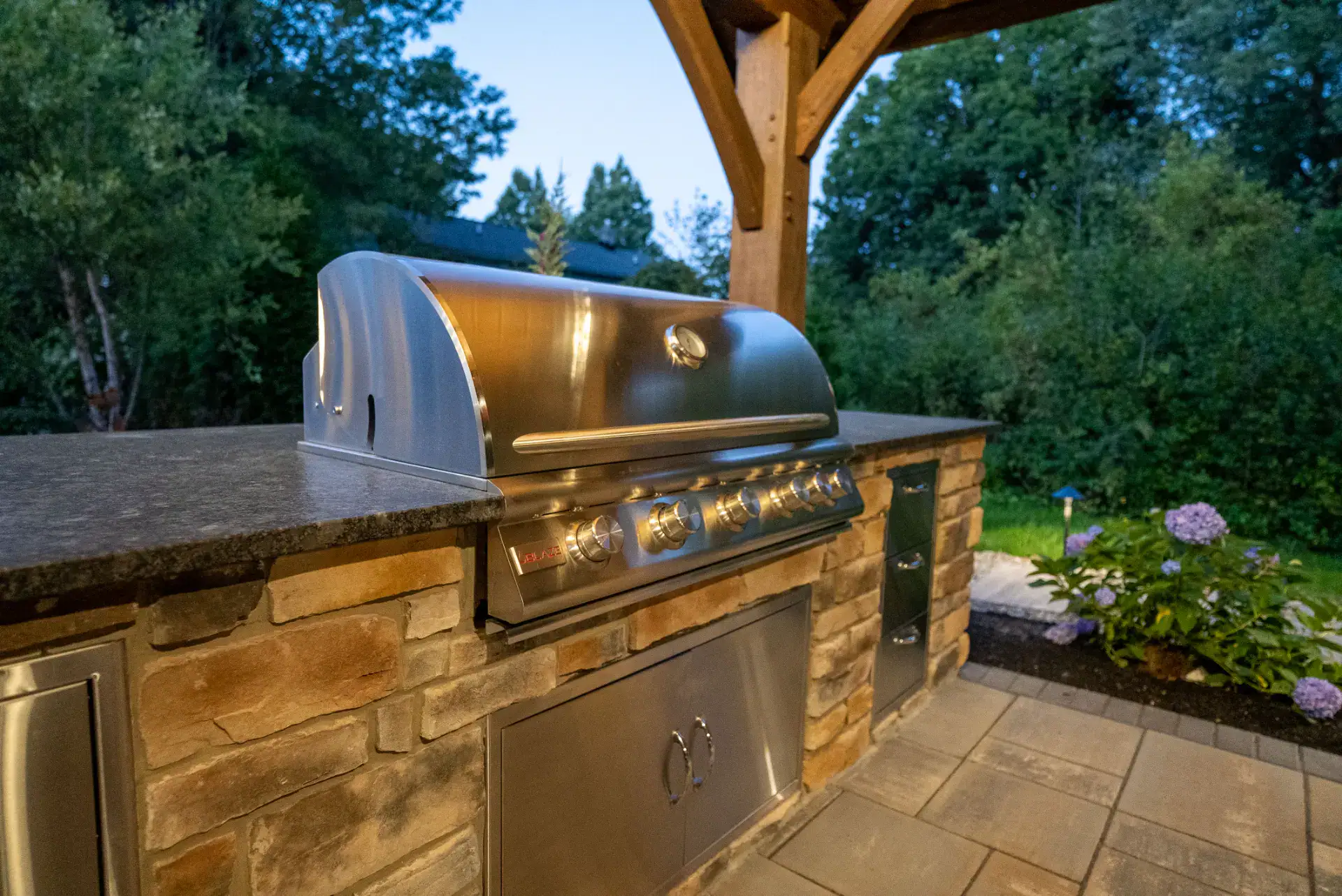 Built-in grill and granite counter in an outdoor kitchen in Pepper Pike, Ohio by TAB Property Enhancement