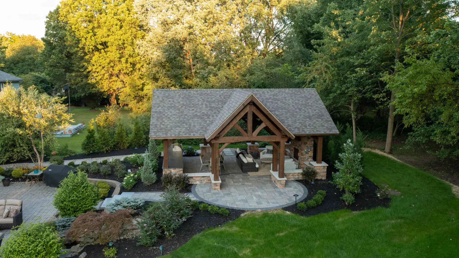 Aerial view of a timber frame pavilion and curved paver patio in Pepper Pike, Ohio by TAB Property Enhancement